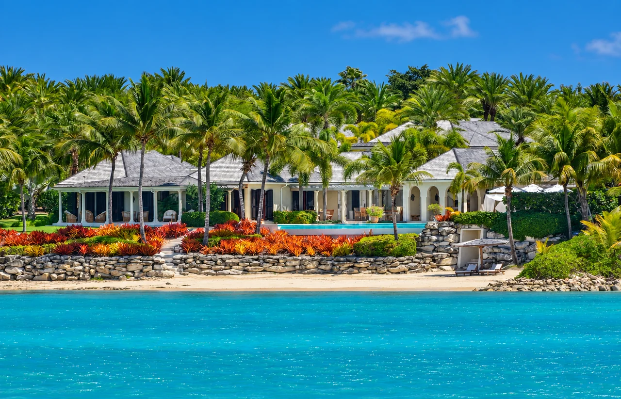 A palm-lined beachfront villa with tropical gardens and turquoise water in Antigua