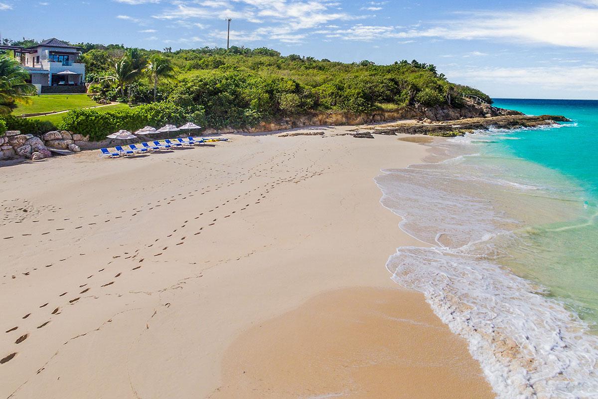 The pale sand and turquoise water of Long Bay beach